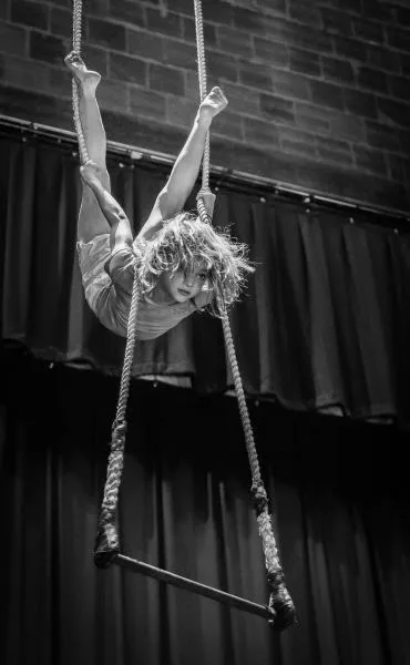 A young Stasia Acrobatics performer posing in costume during a troupe performance.